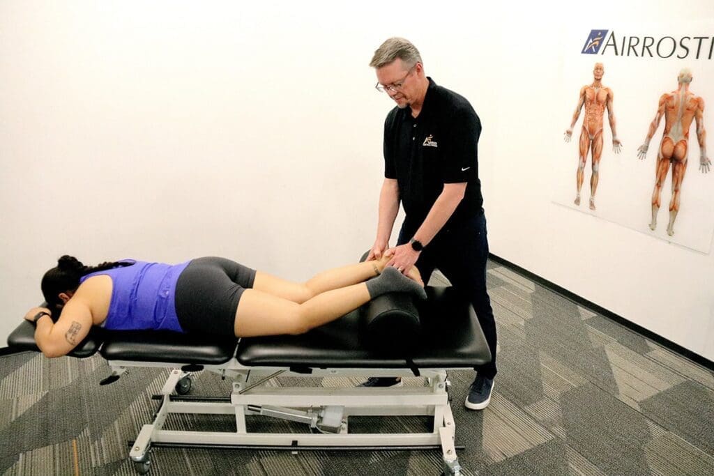 Airrosti Provider performing treatment on patient with Achilles injury